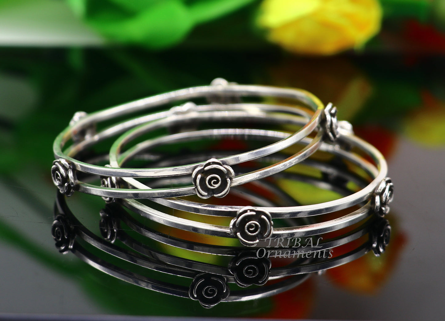Sterling silver flower design bangle bracelet by TRIBAL ORNAMENTS, showcasing intricate handmade floral jewelry for brides.