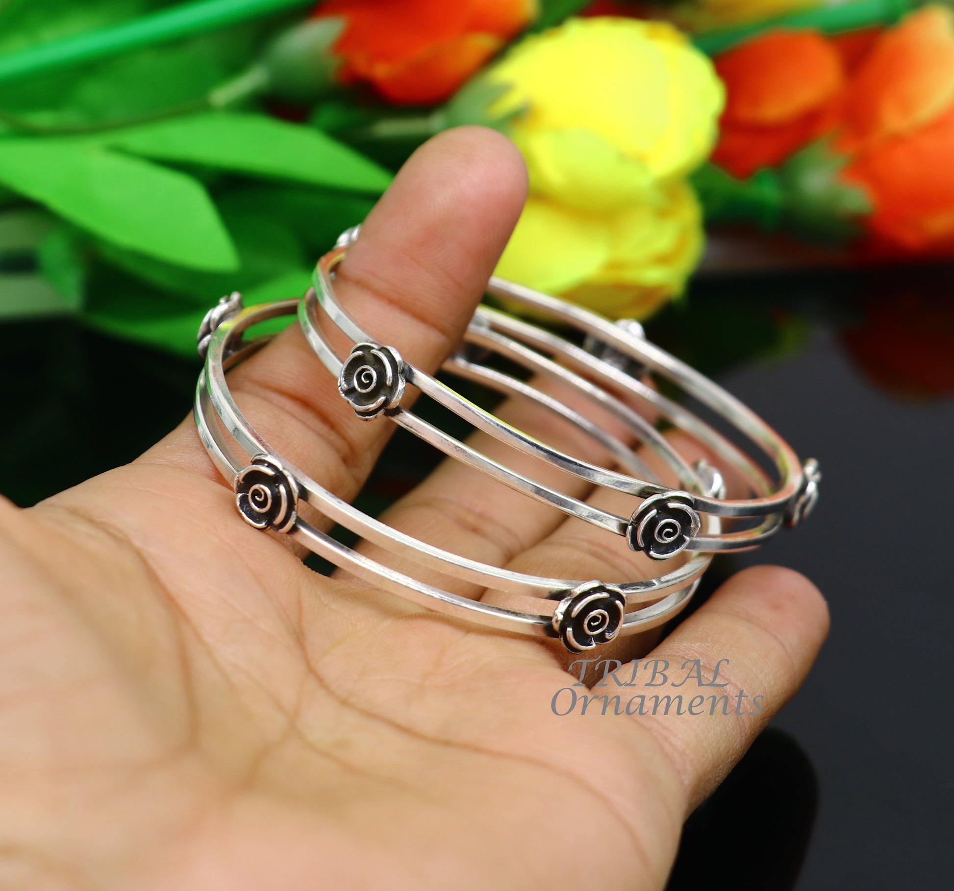 Sterling silver flower design bangle bracelet by TRIBAL ORNAMENTS, handcrafted wedding jewelry with intricate floral details.