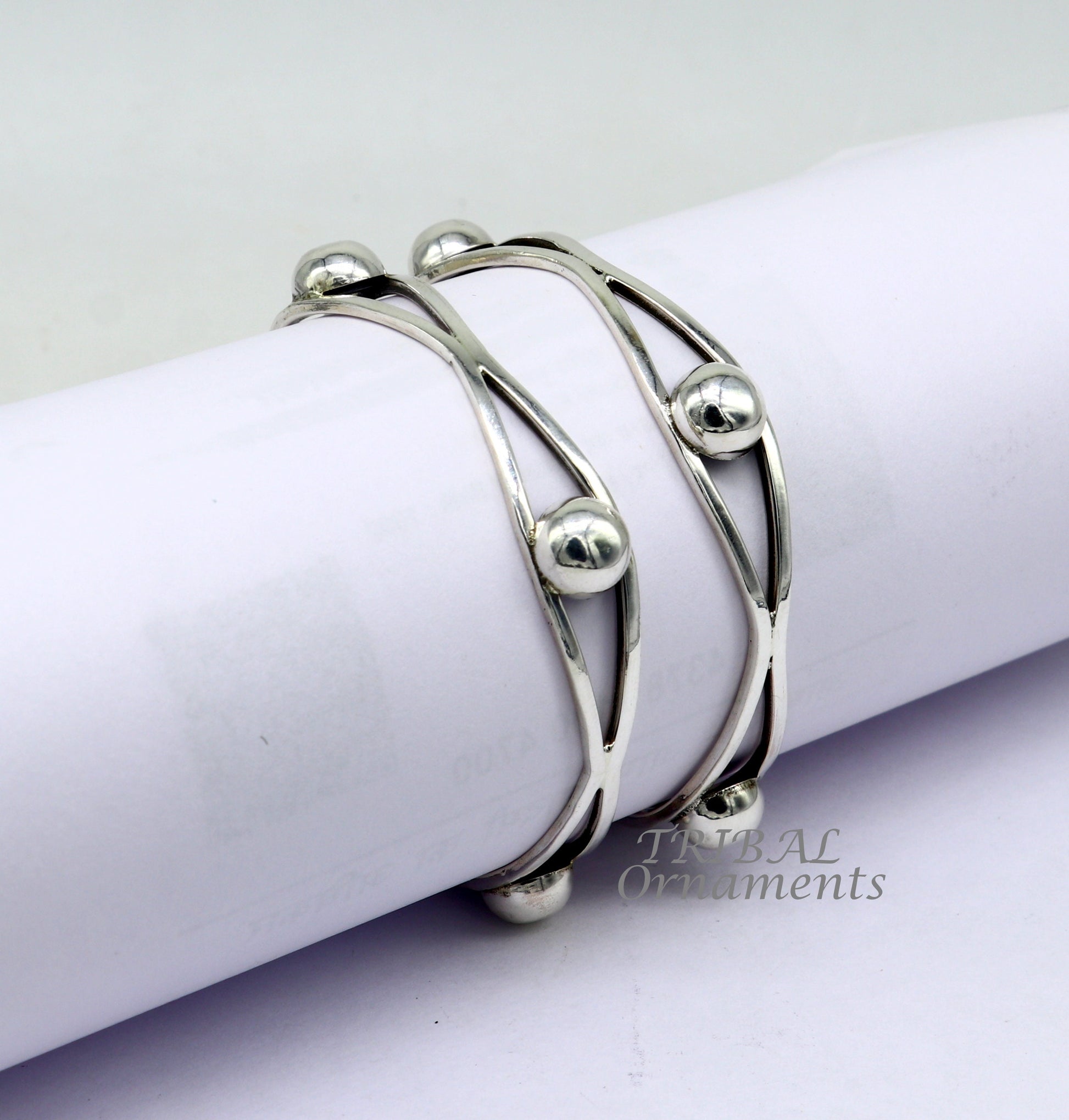 Sterling silver ball design bangle bracelet by TRIBAL ORNAMENTS, handcrafted wedding jewelry with floral details from India.