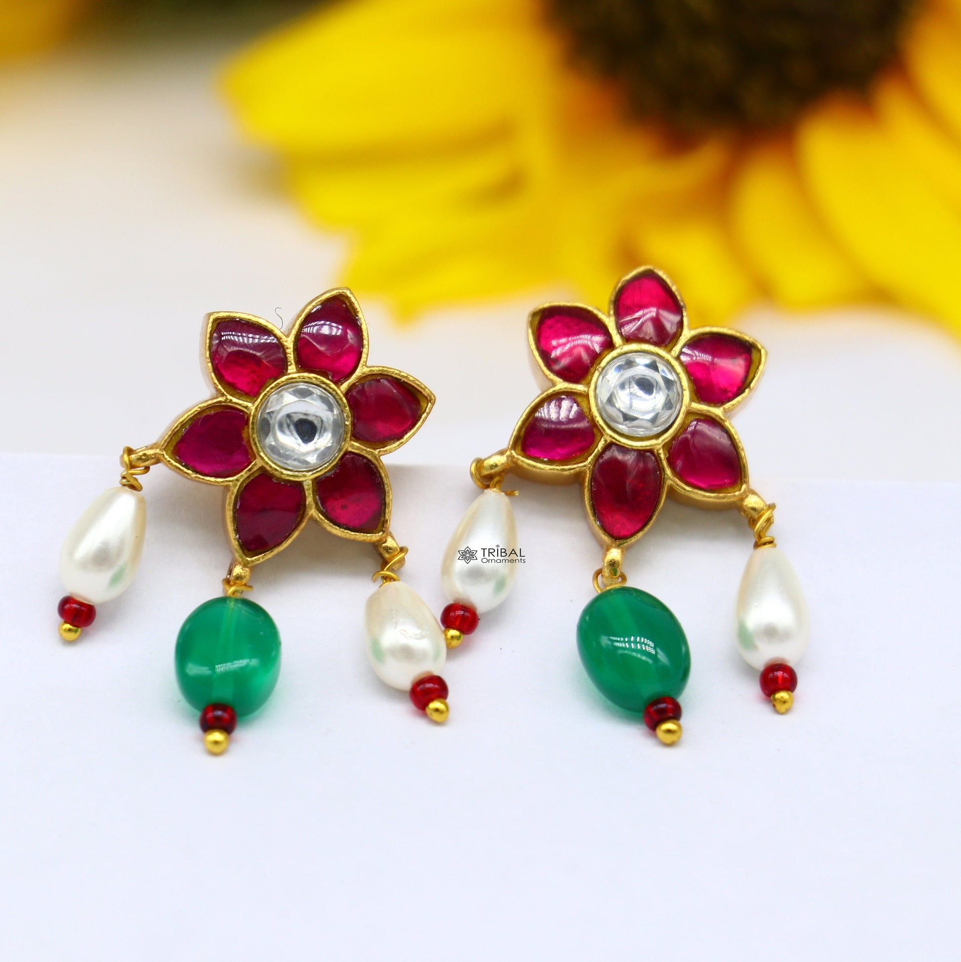 925 sterling silver gold polished kundan work stud earrings with green and red stones in a floral shape, modern trendy jewelry.