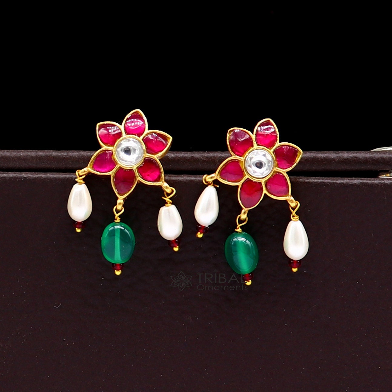 Sterling silver gold-polished kundan work flower-shaped stud earrings with green and red stones, modern trendy jewelry by TRIBAL ORNAMENTS.