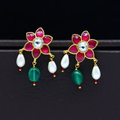 Sterling silver gold-polished kundan work flower-shaped stud earrings with green and red stones, modern trendy jewelry by TRIBAL ORNAMENTS.