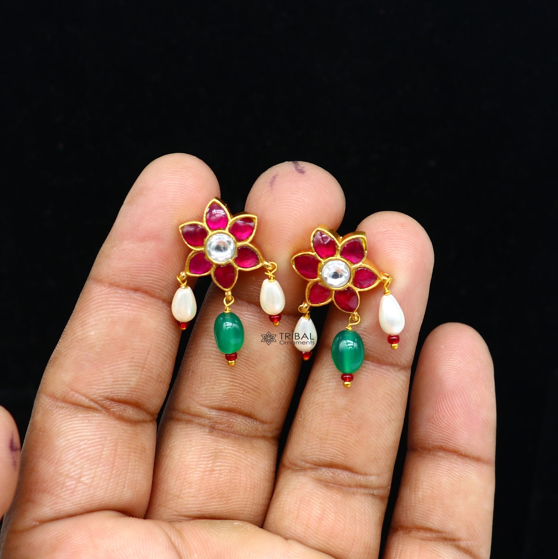 Sterling silver gold-polished handmade kundan flower-shaped stud earrings with green and red stones, trendy tribal jewelry.