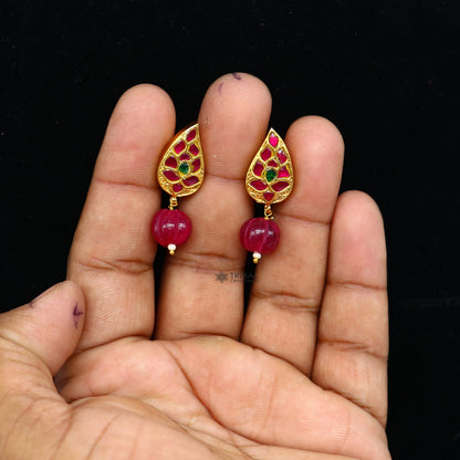 925 silver gold-polished kundan flower-shaped stud earrings with green and red stones by TRIBAL ORNAMENTS.