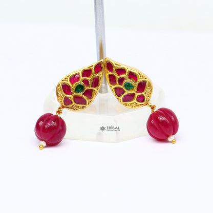 Sterling silver gold-polished handmade kundan flower-shaped stud earrings with green and red stones, modern tribal jewelry.