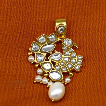 Sterling silver and gold-plated peacock pendant with red and green stone drops, stylish tribal jewelry design.