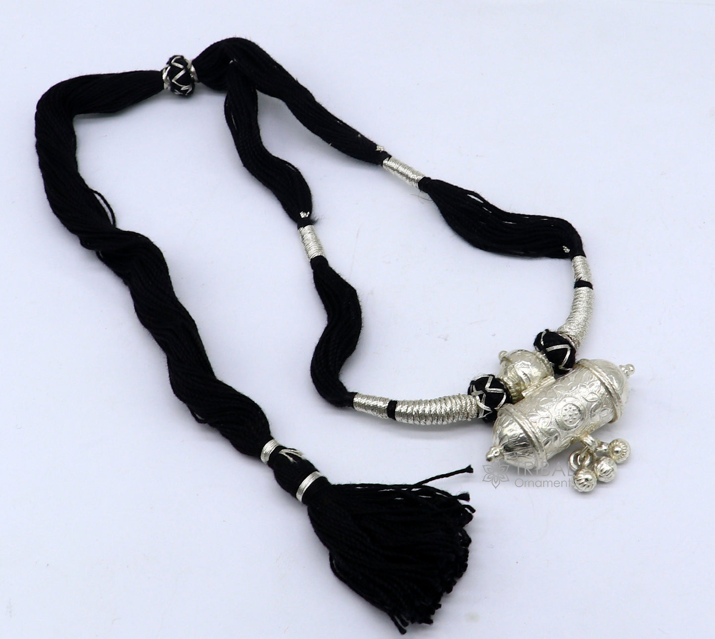 925 sterling silver tribal amulet pendant on ethnic necklace with adjustable back thread knot, part of cultural jewelry set.