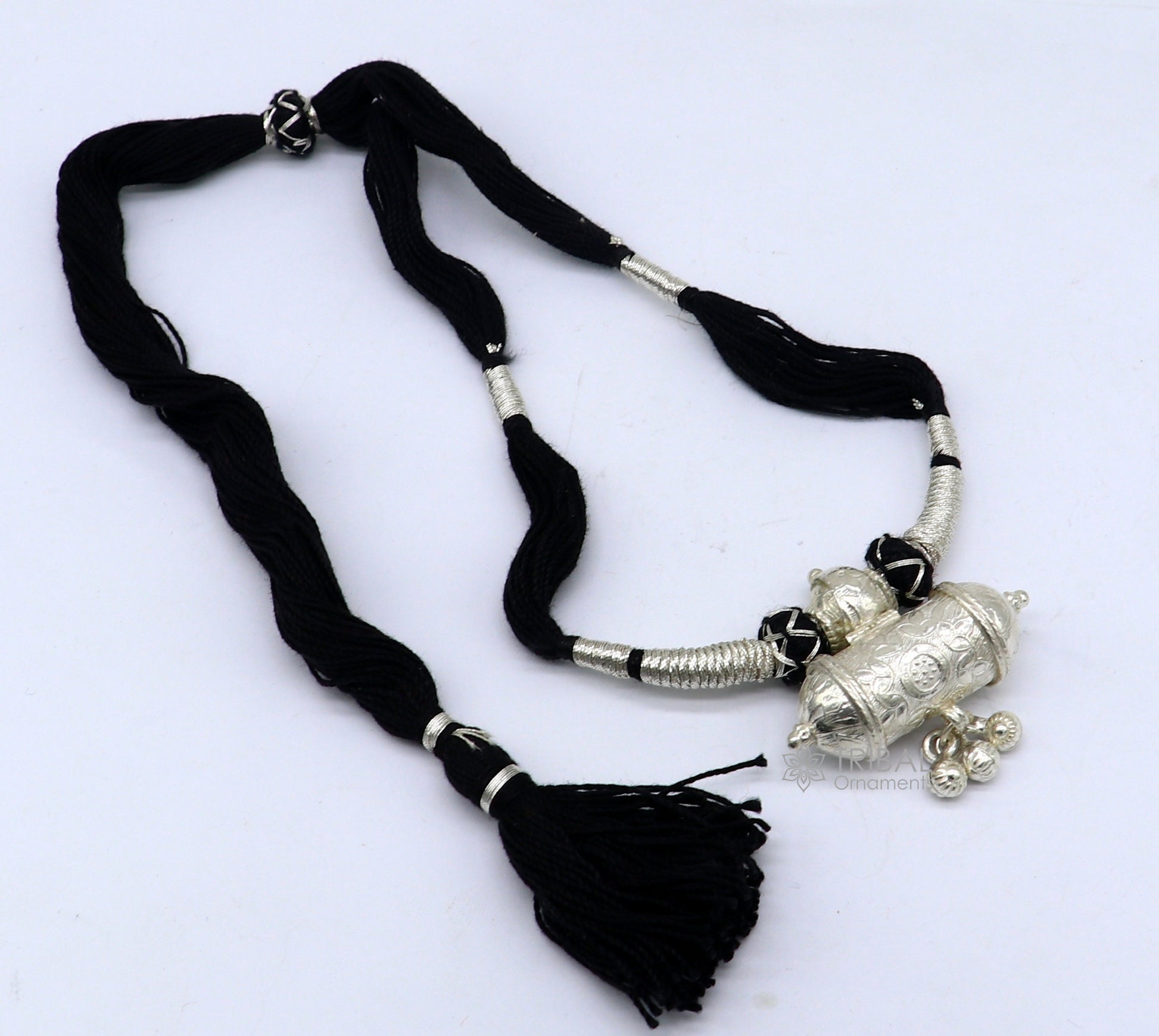 925 sterling silver tribal amulet pendant on ethnic necklace with adjustable back thread knot, part of cultural jewelry set.