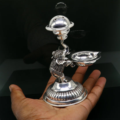 Handcrafted 925 sterling silver elephant oil lamp and incense stick holder, traditional puja utensil with intricate tribal design.