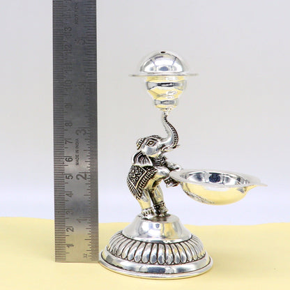 925 silver handcrafted elephant oil lamp and incense stick holder, traditional puja utensil with detailed tribal ornament design.