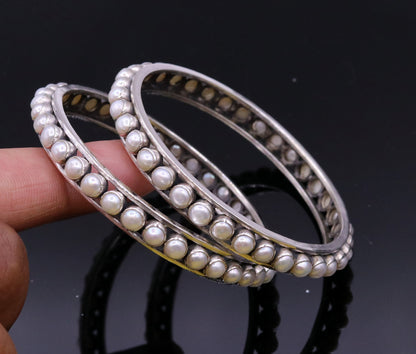 925 sterling silver pearl bangle bracelet with oxidized finish, featuring a floral design, perfect for bridal or gift jewelry.