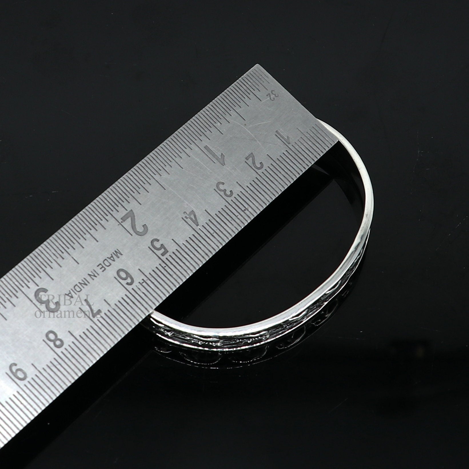 Sterling silver elephant design bangle cuff bracelet by TRIBAL ORNAMENTS, featuring waved open-face jewelry for unisex gifting.