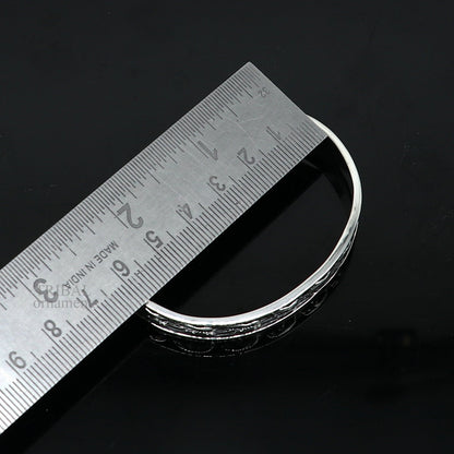 Sterling silver elephant design bangle cuff bracelet by TRIBAL ORNAMENTS, featuring waved open-face jewelry for unisex gifting.