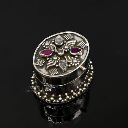 Handcrafted 925 sterling silver oval trinket box with red stone accents, used for jewelry, kajal, or sindur, by Tribal Ornaments.