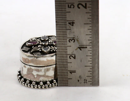 Handcrafted 925 sterling silver oval trinket box with red stone accents, used for jewelry, kajal, or sindur, by Tribal Ornaments.