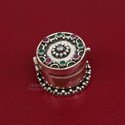 Handcrafted 925 silver round trinket box with red stone accents, ideal for jewelry, kajal, or sindur storage, by TRIBAL ORNAMENTS.