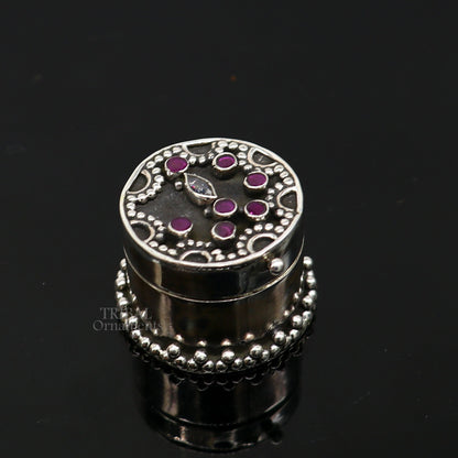 Handcrafted 925 sterling silver round trinket box with red stone work, ideal for jewelry, kajal, or sindur storage, by TRIBAL ORNAMENTS.