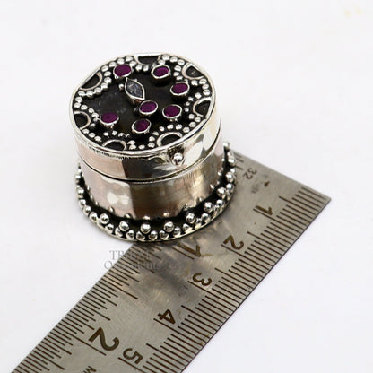 Handcrafted 925 sterling silver round trinket box with red stone accents, ideal for jewelry, kajal, or sindur storage, by TRIBAL ORNAMENTS.