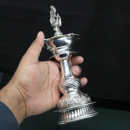 Handcrafted 925 sterling silver vintage oil lamp, Deepak, with antique design and detailed candle stand, used for puja rituals.
