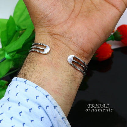 Handcrafted 925 sterling silver vintage-style bangle cuff bracelet by TRIBAL ORNAMENTS, featuring intricate tribal design and adjustable fit.