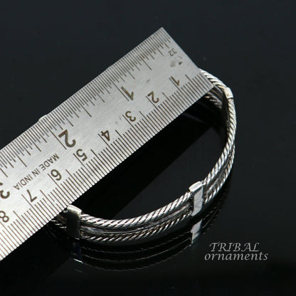 Handcrafted vintage-style 925 sterling silver bangle cuff bracelet with intricate tribal design, adjustable for men and women.
