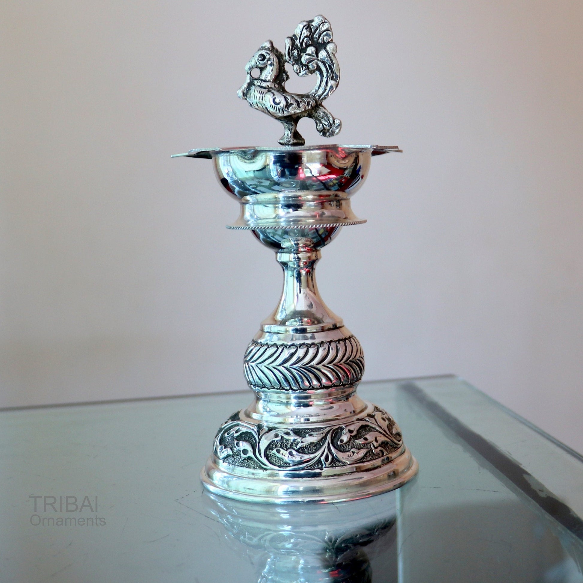 Handcrafted 925 sterling silver vintage oil lamp or candle stand, traditional Deepak for puja, with detailed silver figurine.