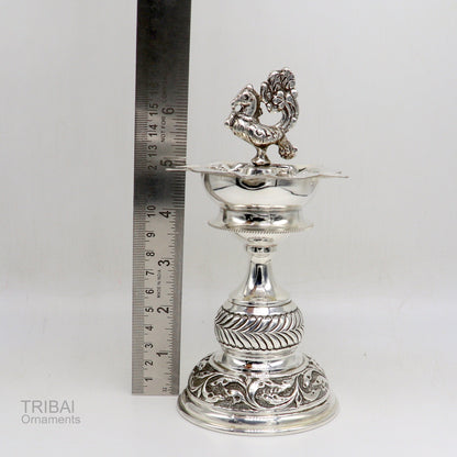 Handcrafted 925 sterling silver vintage oil lamp or candle stand with detailed silver Deepak and puja utensils, traditional silver figurine.