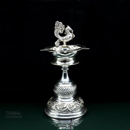 Handcrafted 925 sterling silver vintage oil lamp or candle stand, tribal Deepak puja utensil with detailed silver figurine, tribal ornaments.