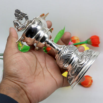 Handcrafted vintage 925 sterling silver oil lamp or candle stand, traditional Deepak with detailed silver puja utensils and figurine.
