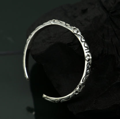 Sterling silver tribal-style bangle cuff bracelet for men and women, featuring handcrafted, glossy, solid design by TRIBAL ORNAMENTS.