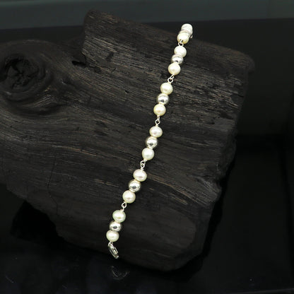 Sterling silver round bead and pearl bracelet by Tribal Ornaments, handcrafted beaded jewelry with 5.5mm beads, stylish and customizable.