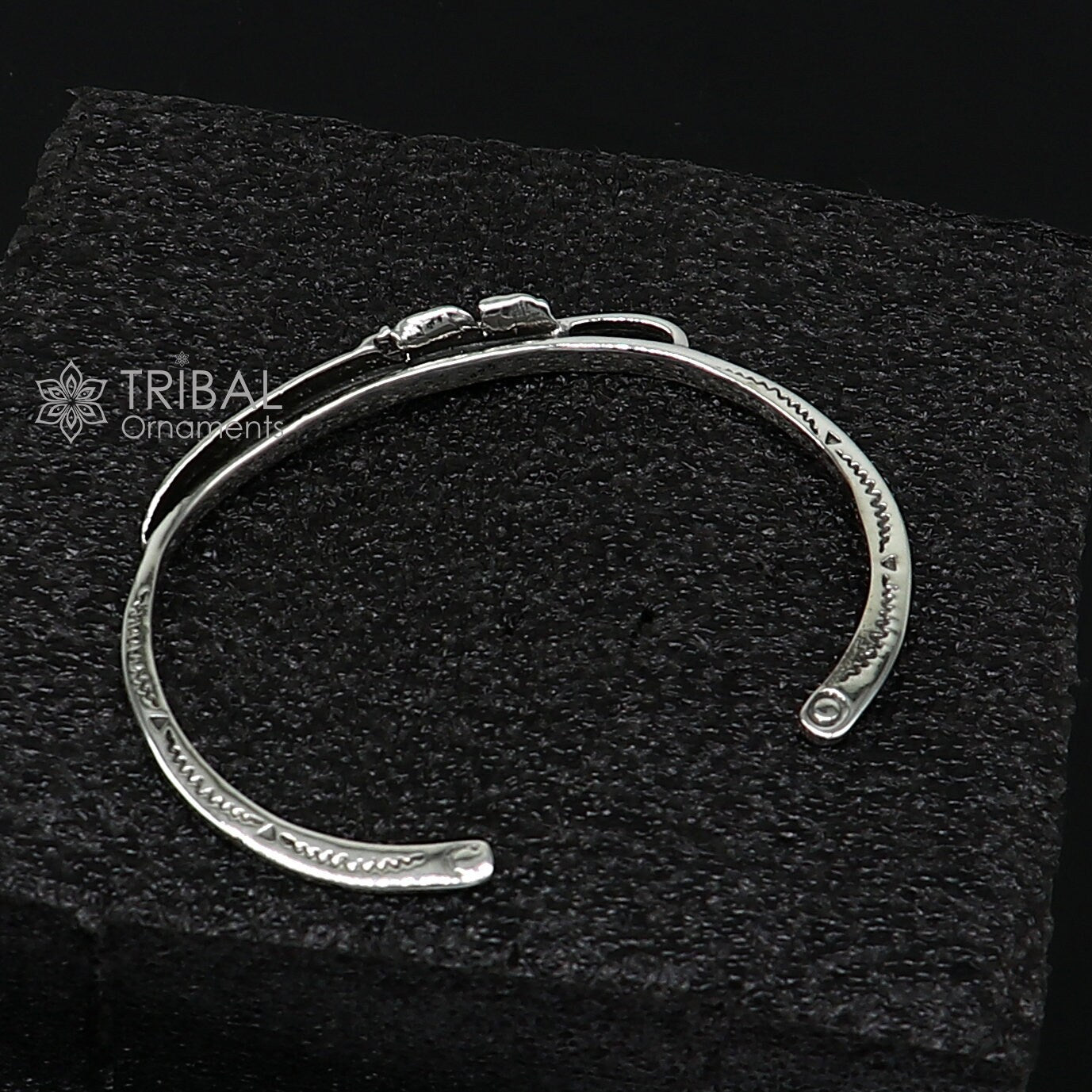 Sterling silver feather design adjustable cuff bracelet by TRIBAL ORNAMENTS, unisex jewelry with modern, stylish details.