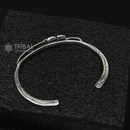 Sterling silver feather design adjustable cuff bracelet by TRIBAL ORNAMENTS, unisex jewelry with modern, stylish details.