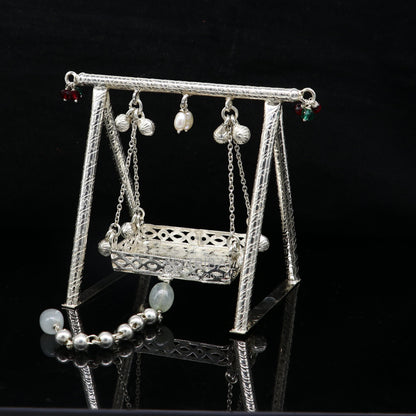Handmade 925 sterling silver Bal Gopala Krishna swing jewelry, featuring a detailed child Krishna figure on a silver jhula.