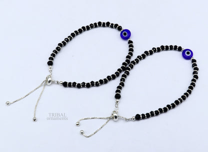 Sterling silver handmade evil eye beaded bracelet by TRIBAL ORNAMENTS, adjustable for girls and toddlers, featuring colorful bead accents.