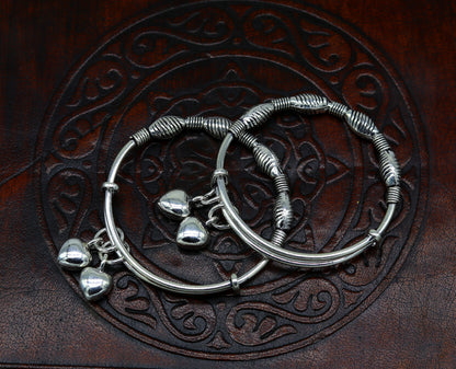 Sterling silver vintage-style baby bangles with adjustable charm design, handmade tribal jewelry for newborns and kids.