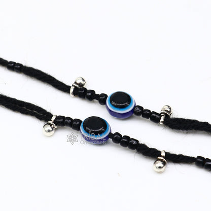 Sterling silver handmade ankle bracelet with evil eye beads, customized thread foot anklet by TRIBAL ORNAMENTS, beach-ready jewelry.