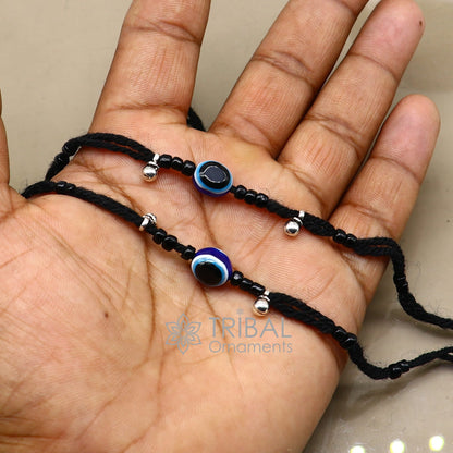 Sterling silver handmade ankle bracelet with evil eye beads and customizable thread design, beach-ready foot jewelry by TRIBAL ORNAMENTS.