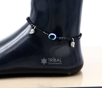 Sterling silver handmade beads with evil eye charms on a customized thread ankle bracelet from TRIBAL ORNAMENTS.