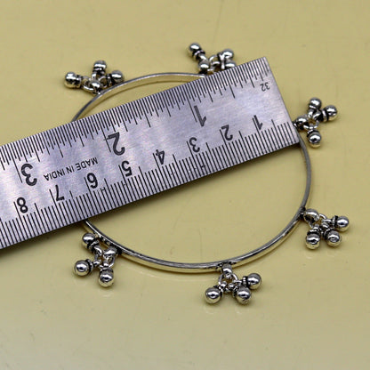 Sterling silver bridesmaid bangle bracelet with hanging bells, handcrafted by Tribal Ornaments for personalized wedding jewelry.