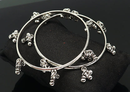 Sterling silver bridesmaid bangle bracelet with hanging bells, handcrafted by TRIBAL ORNAMENTS, personalized wedding jewelry.