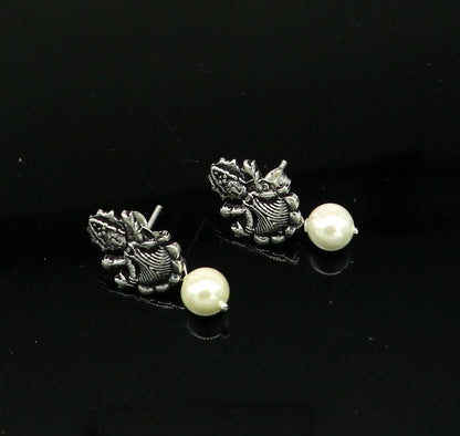 Sterling silver tribal deity goddess stud earring with dangling mother of pearl, handcrafted by Tribal Ornaments.