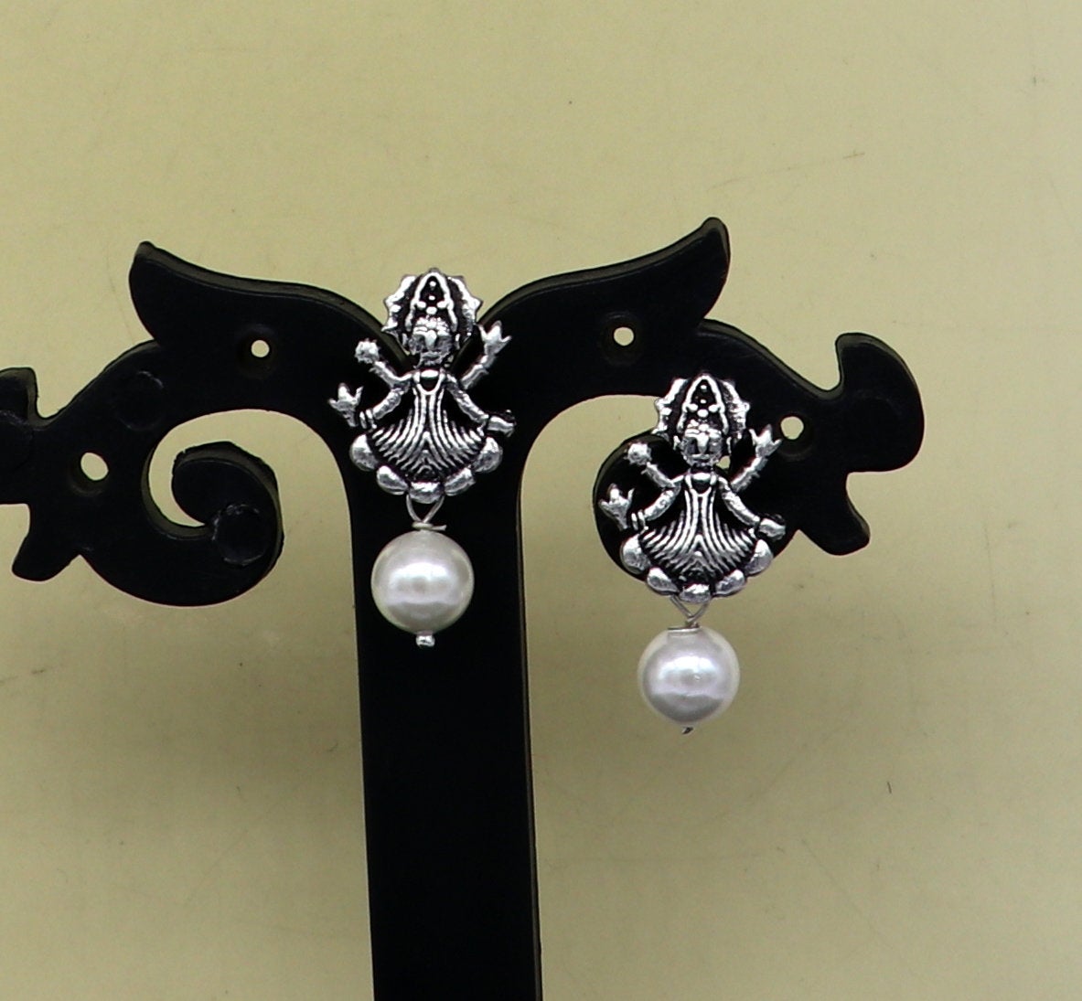 Sterling silver tribal deity goddess stud earring with dangling mother of pearl, handmade with intricate tribal design.