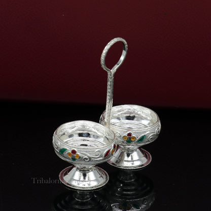 Handmade 925 sterling silver puja utensils including Tilak bowl and kumkum patra by TRIBAL ORNAMENTS, featuring intricate craftsmanship.