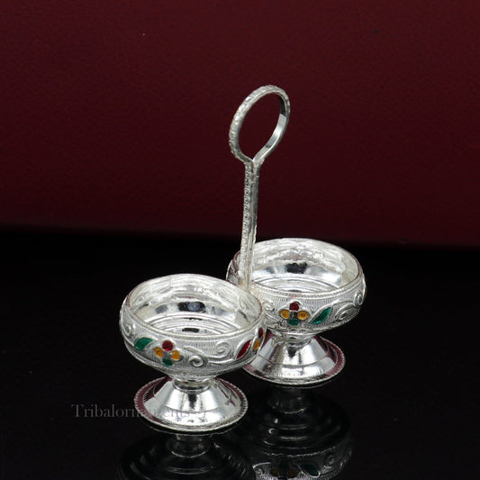 Handmade 925 sterling silver puja utensils including Tilak bowl and kumkum patra by TRIBAL ORNAMENTS, featuring intricate craftsmanship.