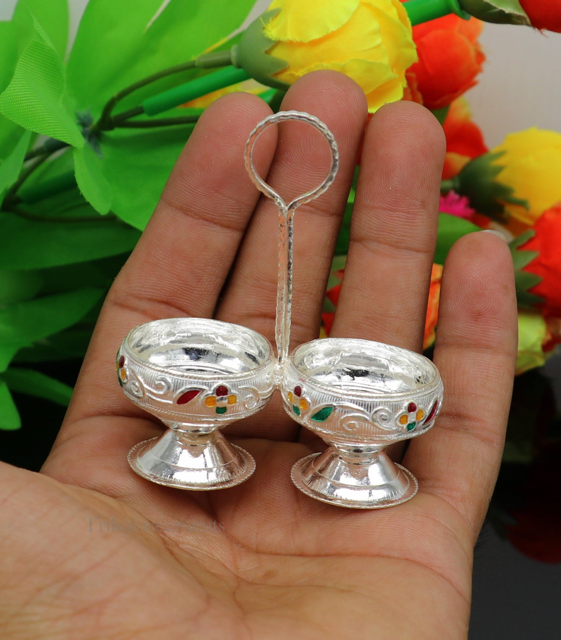 Handmade 925 sterling silver puja utensils including a silver tilak bowl and kumkum patra with intricate tribal design.