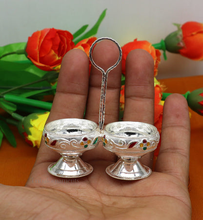 Handmade 925 sterling silver puja utensils including a tilak bowl and kumkum patra, crafted with customized tribal design.