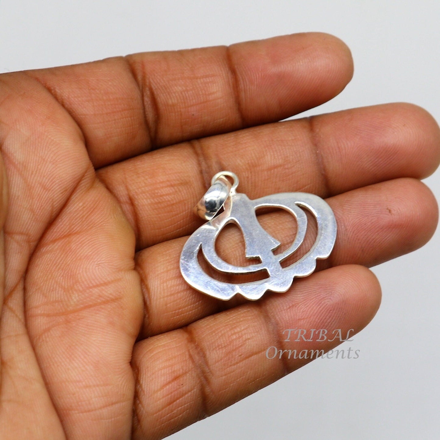 925 sterling silver Khalsa Waheguru pendant featuring Sikha Sardar symbol, handmade tribal design, from Tribal Ornaments.