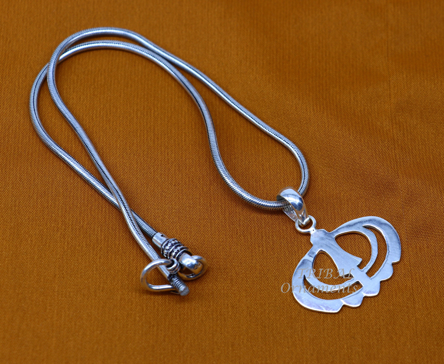 925 sterling silver Khalsa Waheguru pendant featuring Sikh Sardar symbol, handcrafted by Tribal Ornaments from India.