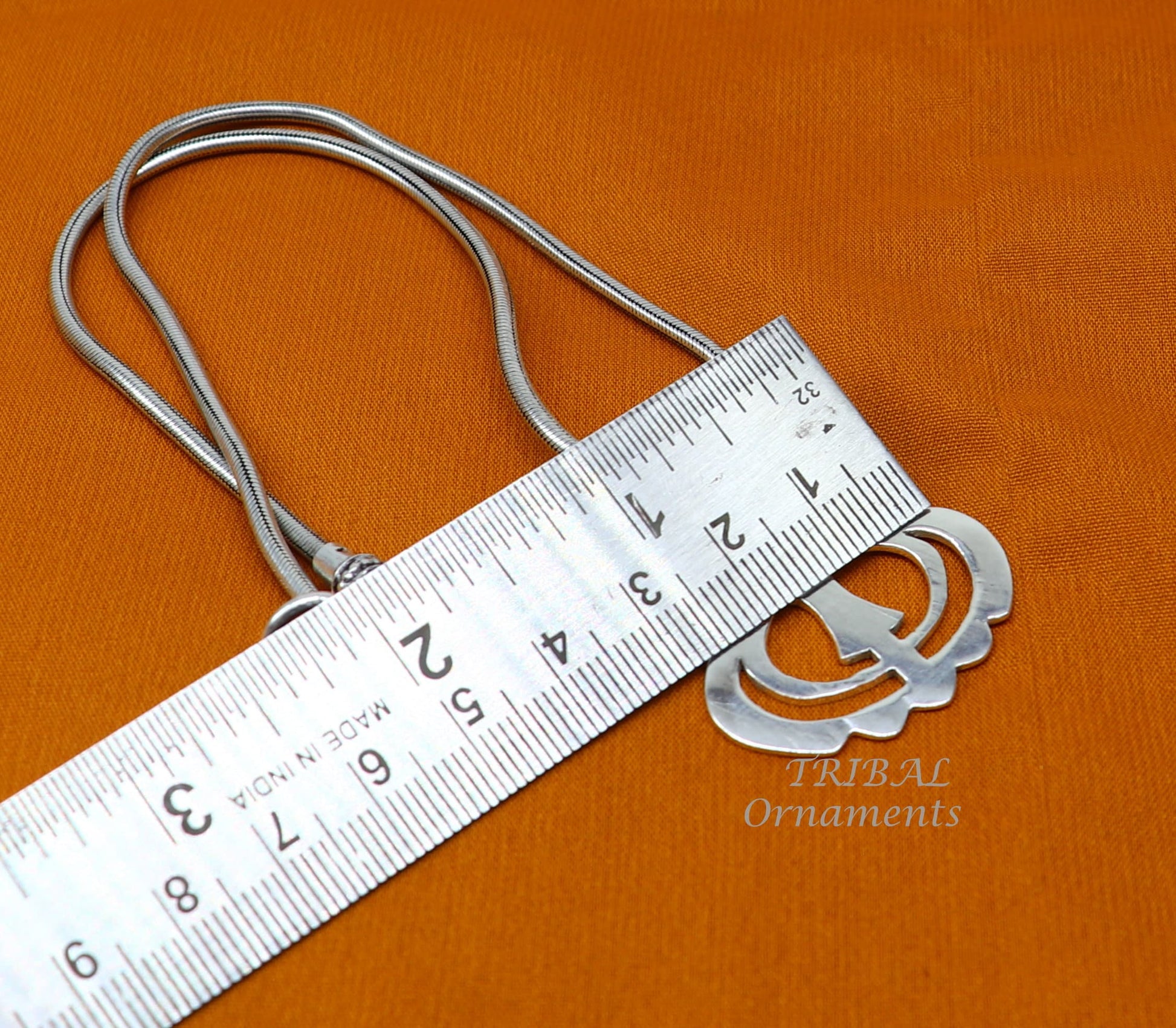 Sterling silver Khalsa Waheguru pendant with Sikha Sardar symbol, handcrafted tribal design, representing spiritual blessing from India.